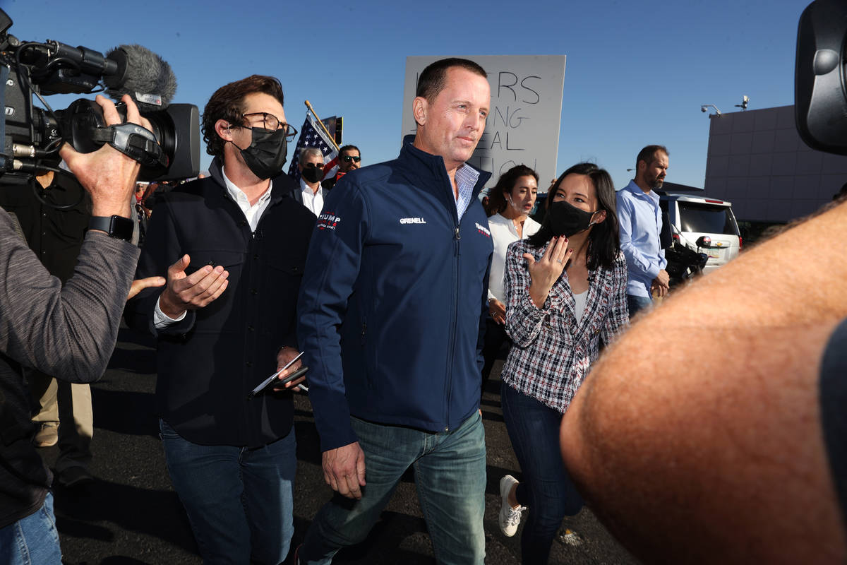 Reporters follow Ric Grenell, former director of National Intelligence, following a N ...