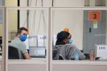 Workers count ballots inside of the Clark County Election Department in North Las Vegas, Thursd ...
