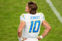 Los Angeles Chargers quarterback Justin Herbert (10) stands on the sidelines against the Denver ...