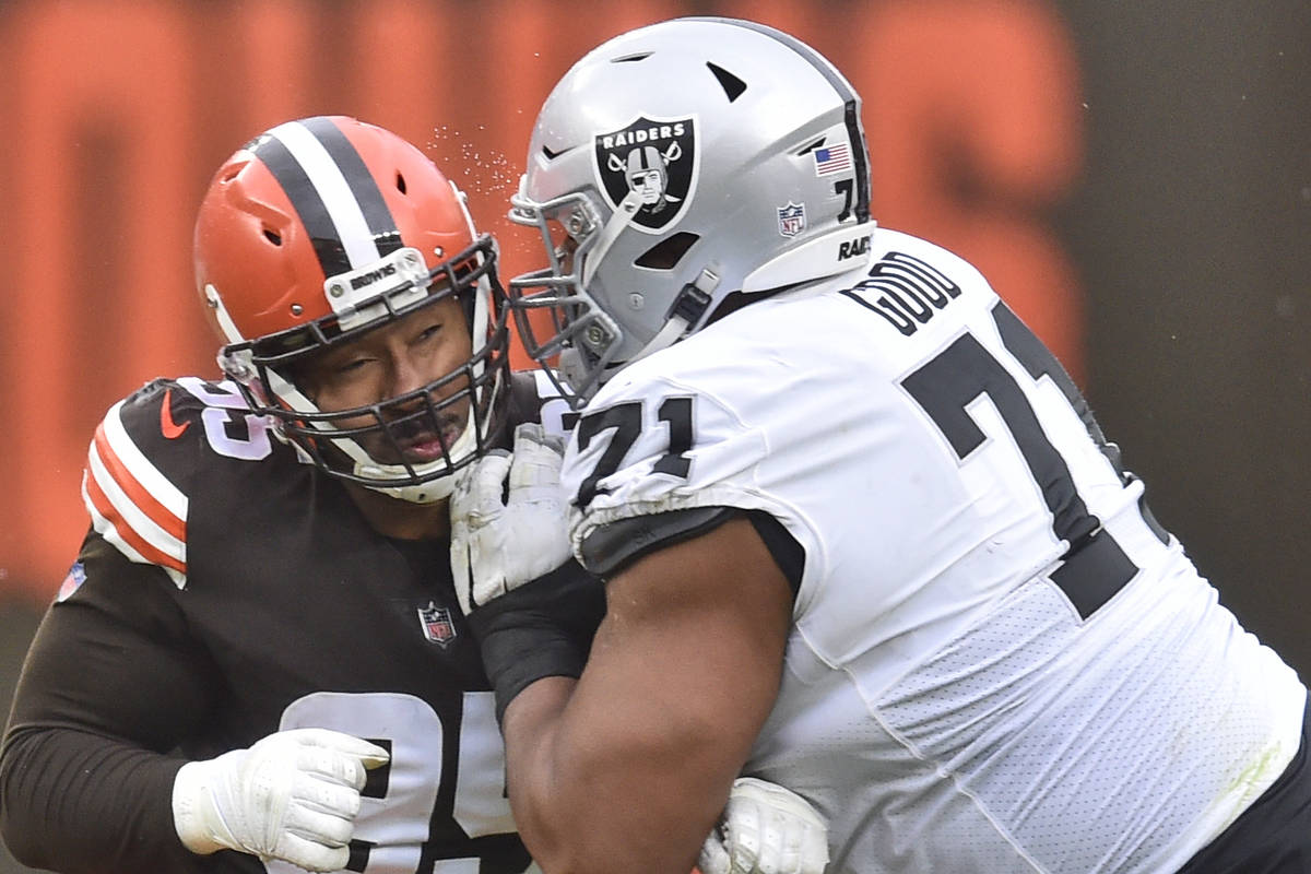 Cleveland Browns defensive end Myles Garrett, left, and Las Vegas Raiders offensive tackle Denz ...