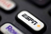 A logo for ESPN is seen on a remote control, in Portland, Ore. (AP Photo/Jenny Kane)
