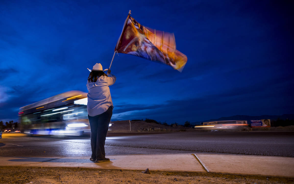 Victoria Giampa waves a President Donald Trump flag along W. Cheyenne Ave. as protests continue ...