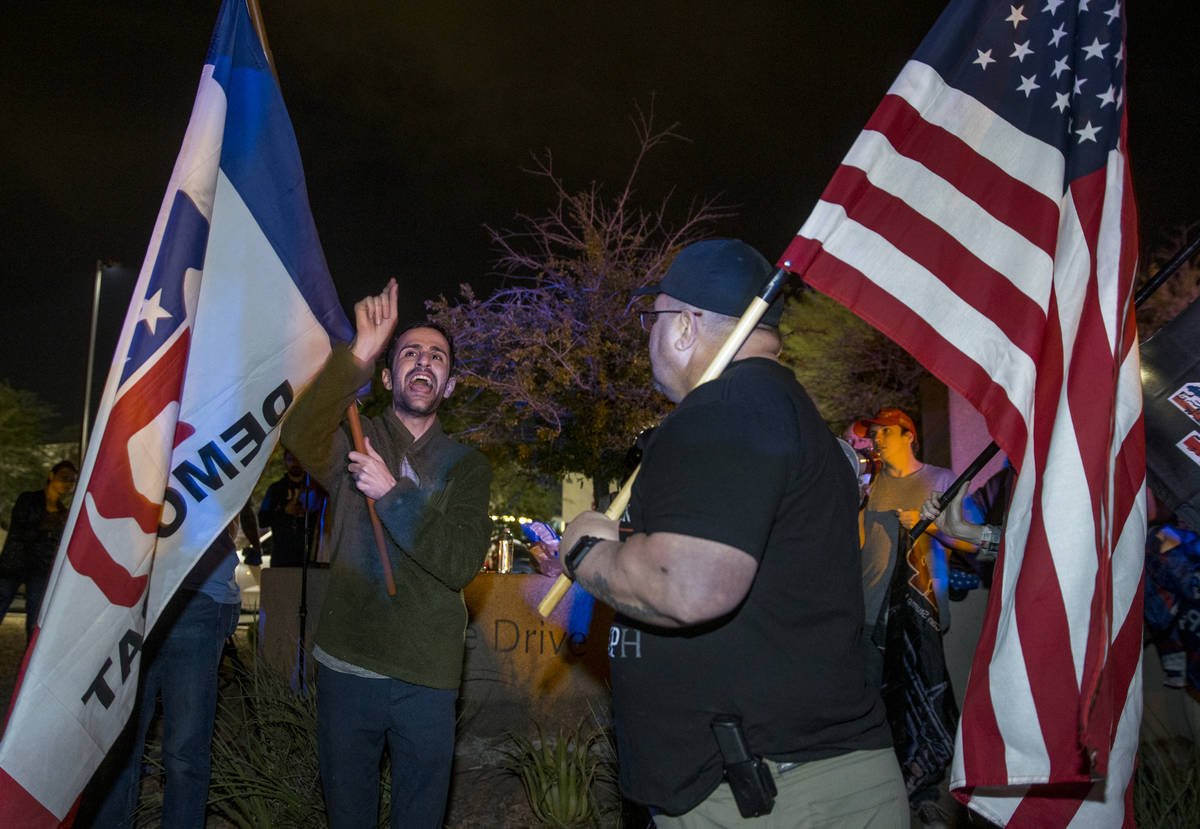 Democrat Kevin (no last name given) debates with a President Donald Trump supporter as protests ...