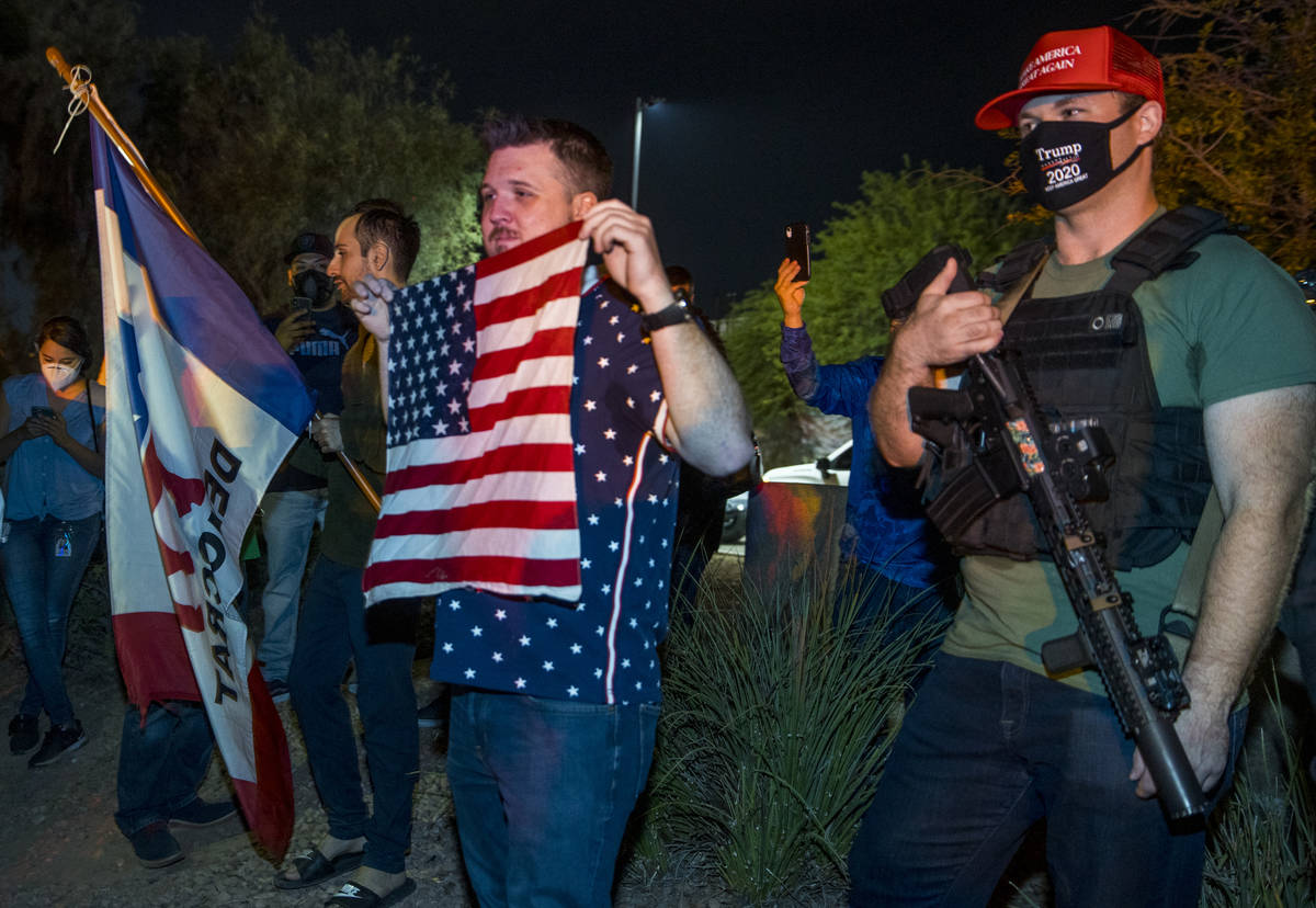 A few armed protesters gather outside the Clark County Election Department as protests attract ...