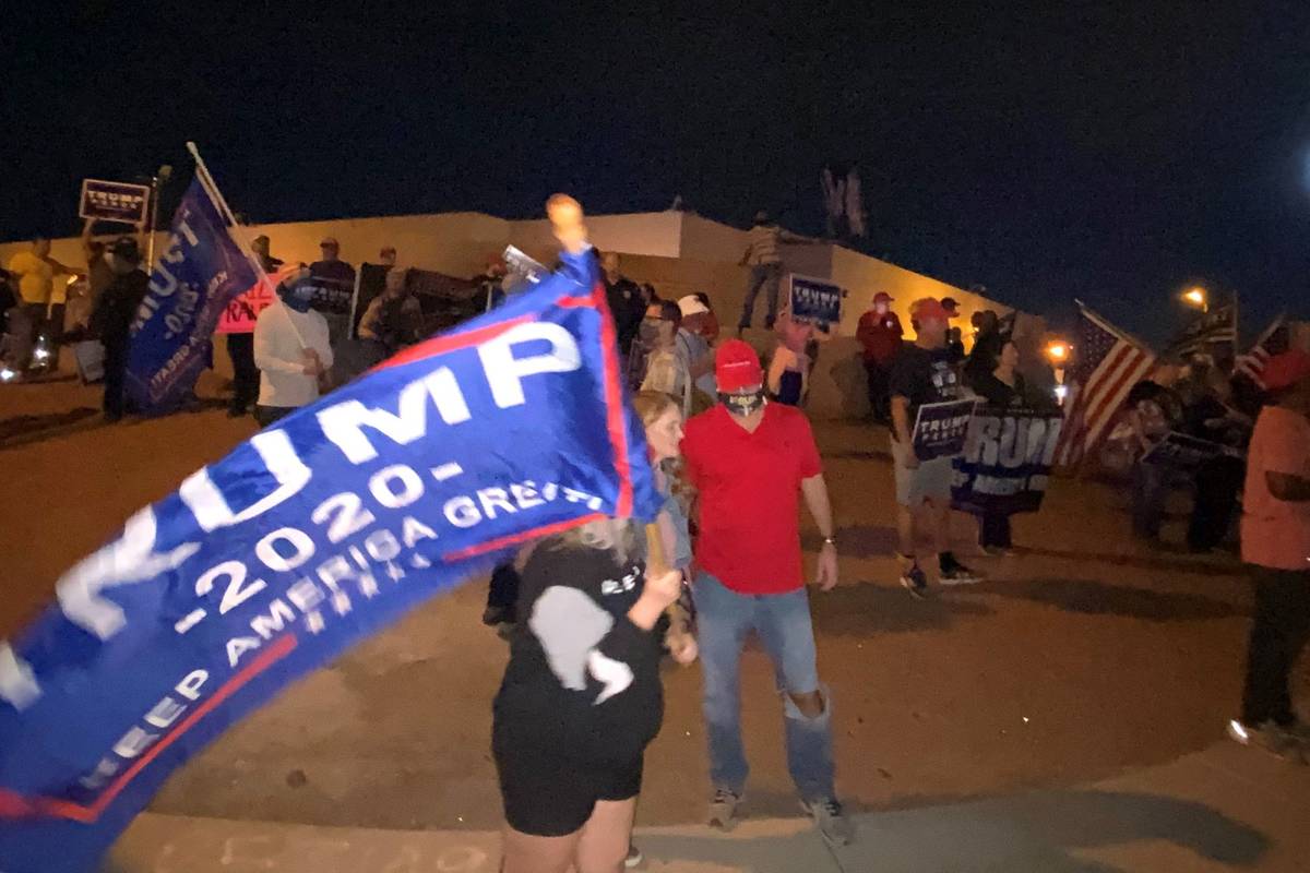 President Donald Trump supporters wave flags and chant Thursday, Nov. 5, 2020, outside the Clar ...