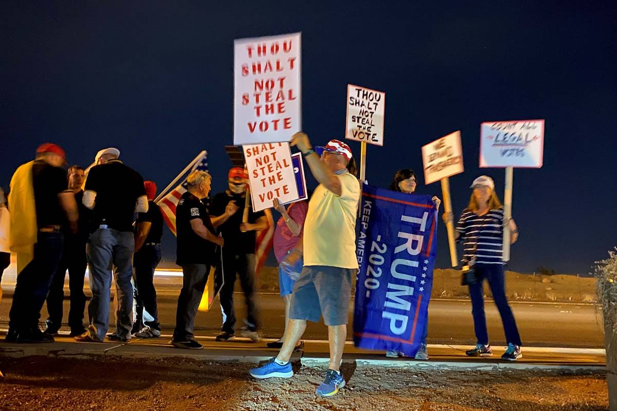 President Donald Trump supporters wave flags and chant Thursday, Nov. 5, 2020, outside the Clar ...