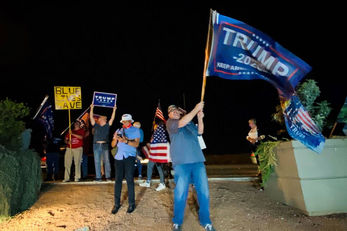 President Donald Trump supporters wave flags and chant Thursday, Nov. 5, 2020, outside the Clar ...