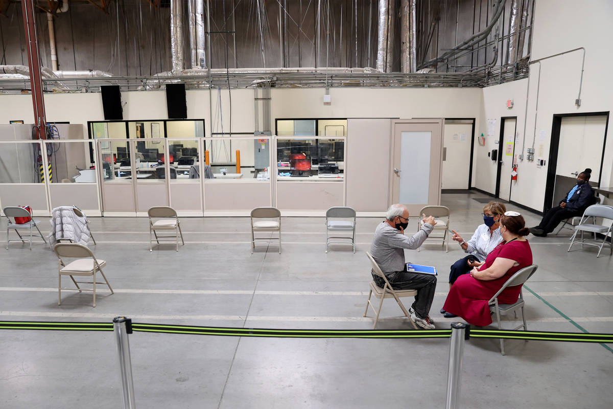 Observers talk to each other at the Clark County Election Department in North Las Vegas, Friday ...