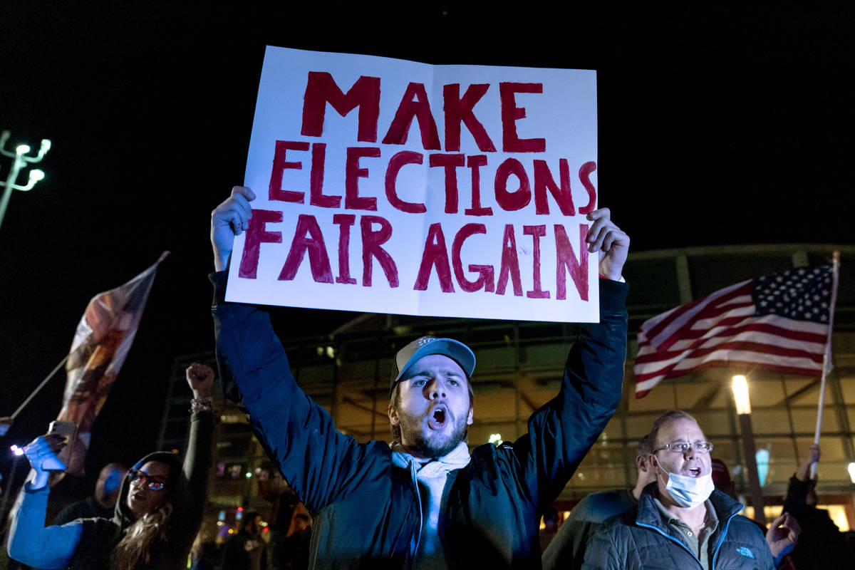 Trump supporter Jake Contos chants during a protest against the election results outside the ce ...