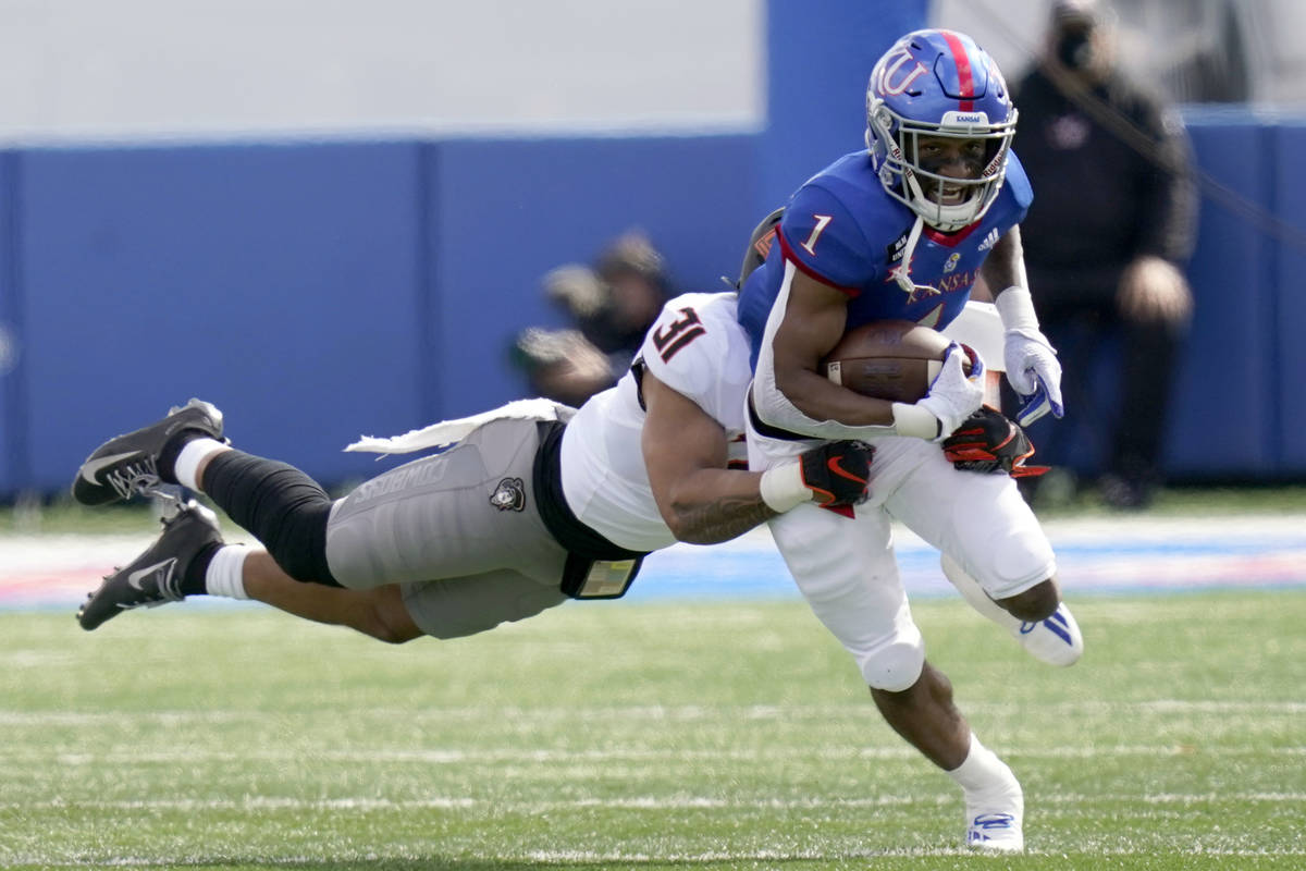 In this Oct. 3, 2020, file photo, Kansas running back Pooka Williams Jr. (1) is tackled by Okla ...