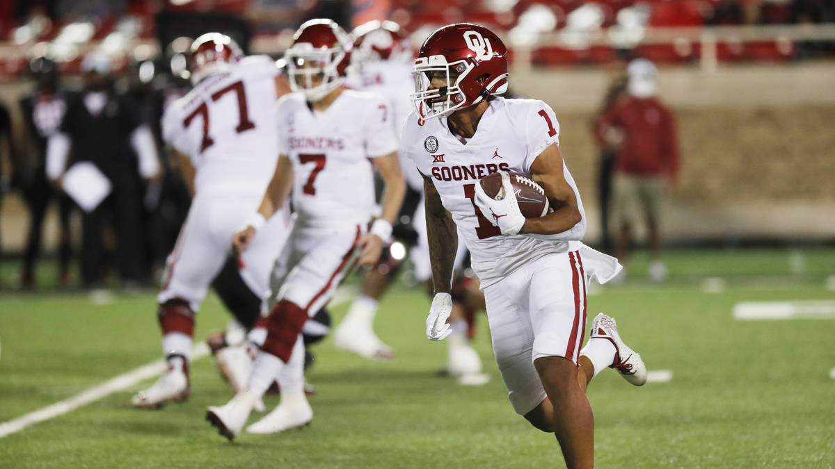 Oklahoma running back Seth McGowan carries the ball in the first half of an NCAA college footba ...