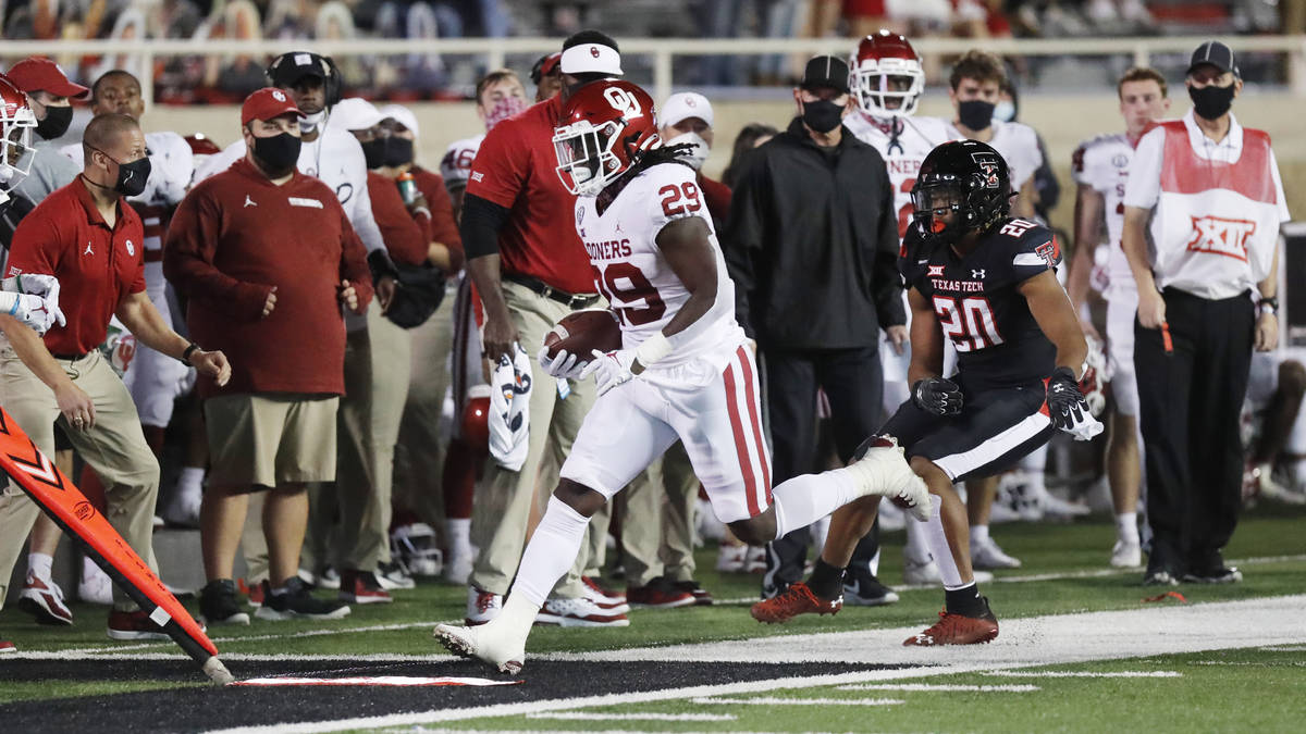 Oklahoma running back Rhamondre Strevenson carries the ball in the first half of an NCAA colleg ...