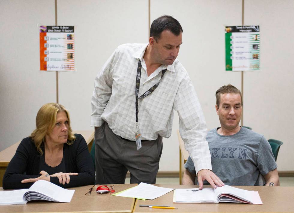 Michael Russell stands by inmates Carrie Kincaid and Andrew Morris as he leads a Moral Recognit ...