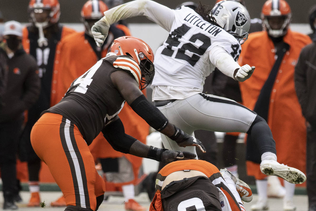 Las Vegas Raiders inside linebacker Cory Littleton (42) leaps over Cleveland Browns quarterback ...