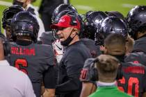 UNLV Rebels head coach Marcus Arroyo, center, speaks to quarterback Max Gilliam (6) and other ...