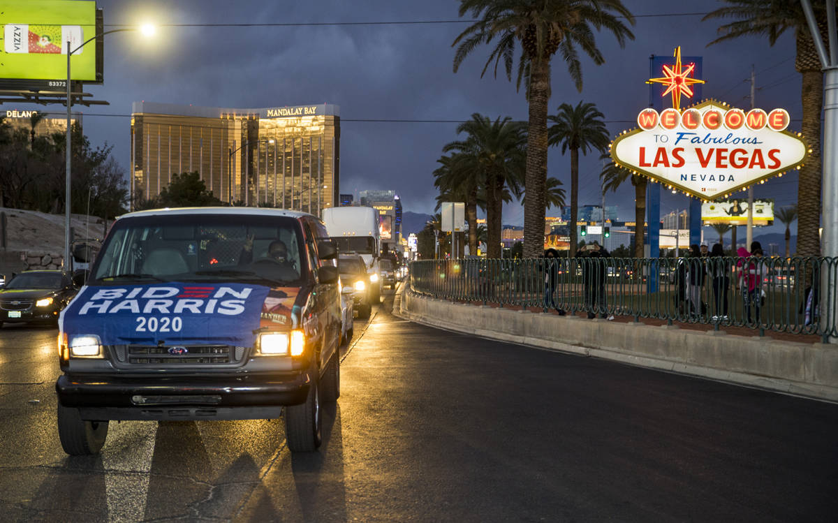 Attendees pass by the Welcome to Fabulous Las Vegas Sign during a car parade down the Las Vegas ...