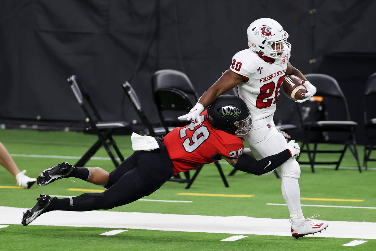 UNLV Rebels defensive back Tre Caine (29) tackles Fresno State Bulldogs running back Ronnie Riv ...