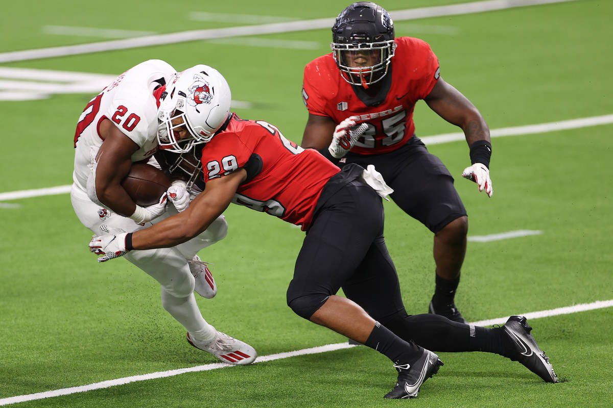 Fresno State Bulldogs running back Ronnie Rivers (20) is tackled by UNLV Rebels defensive back ...
