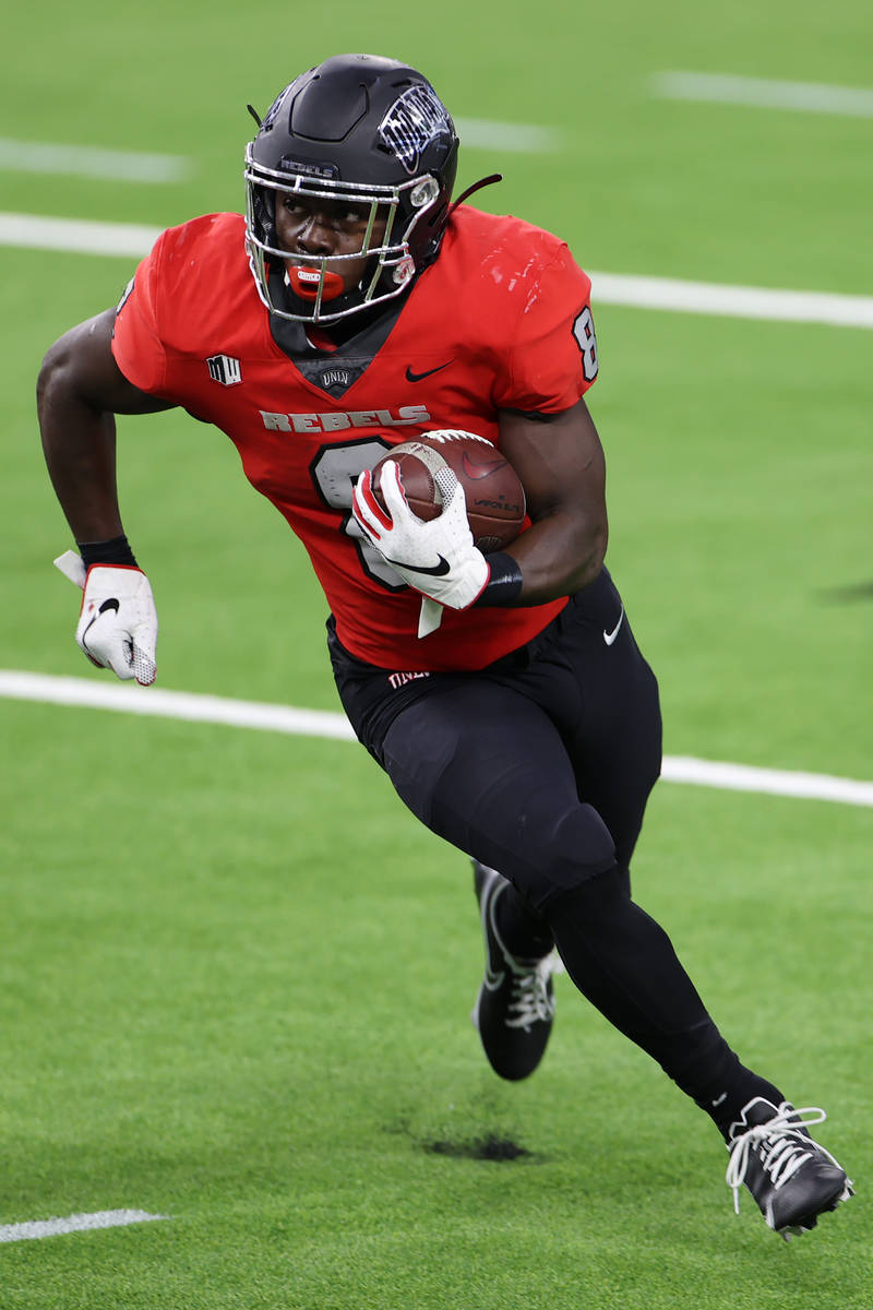 UNLV Rebels running back Charles Williams (8) runs the ball against the Fresno State Bulldogs d ...