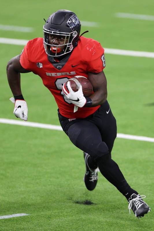 UNLV Rebels running back Charles Williams (8) runs the ball against the Fresno State Bulldogs d ...