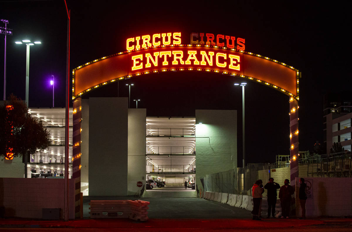 People stand outside of a parking lot entrance at Circus Circus where multiple people were shot ...