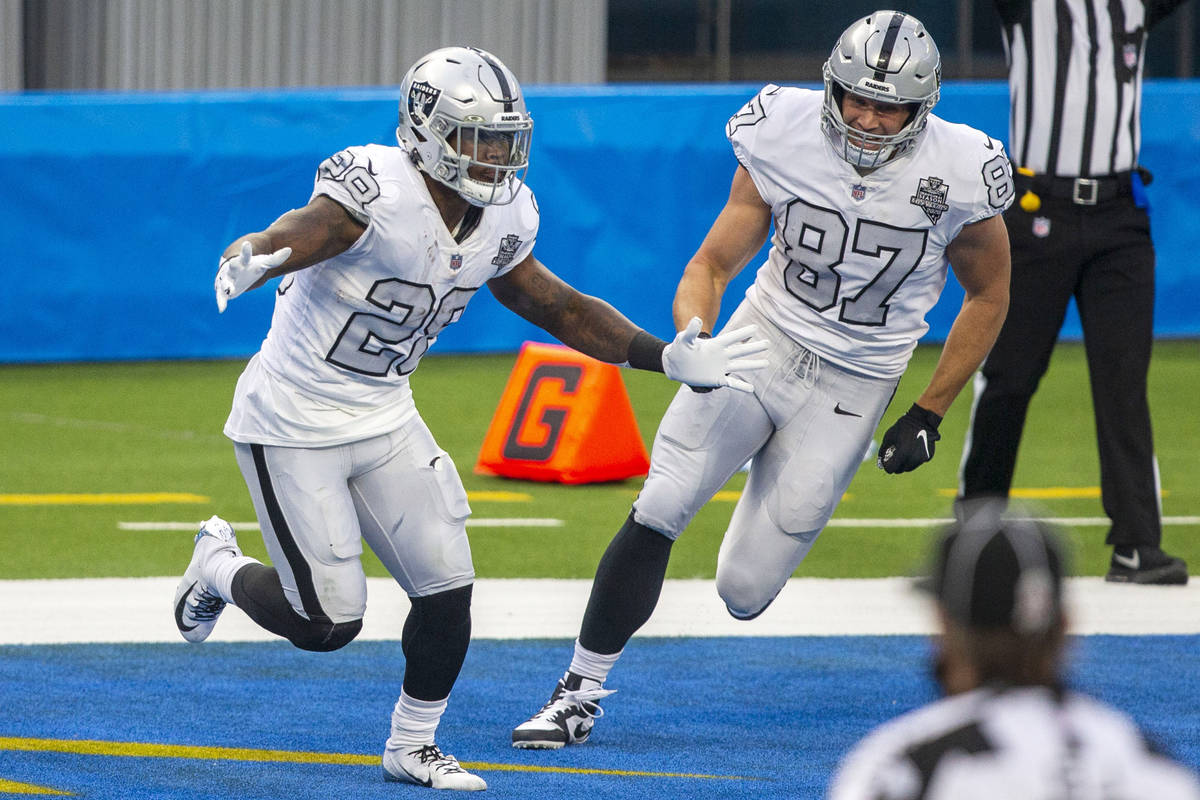 Las Vegas Raiders running back Josh Jacobs (28) celebrates his touchdown run with tight end Fos ...