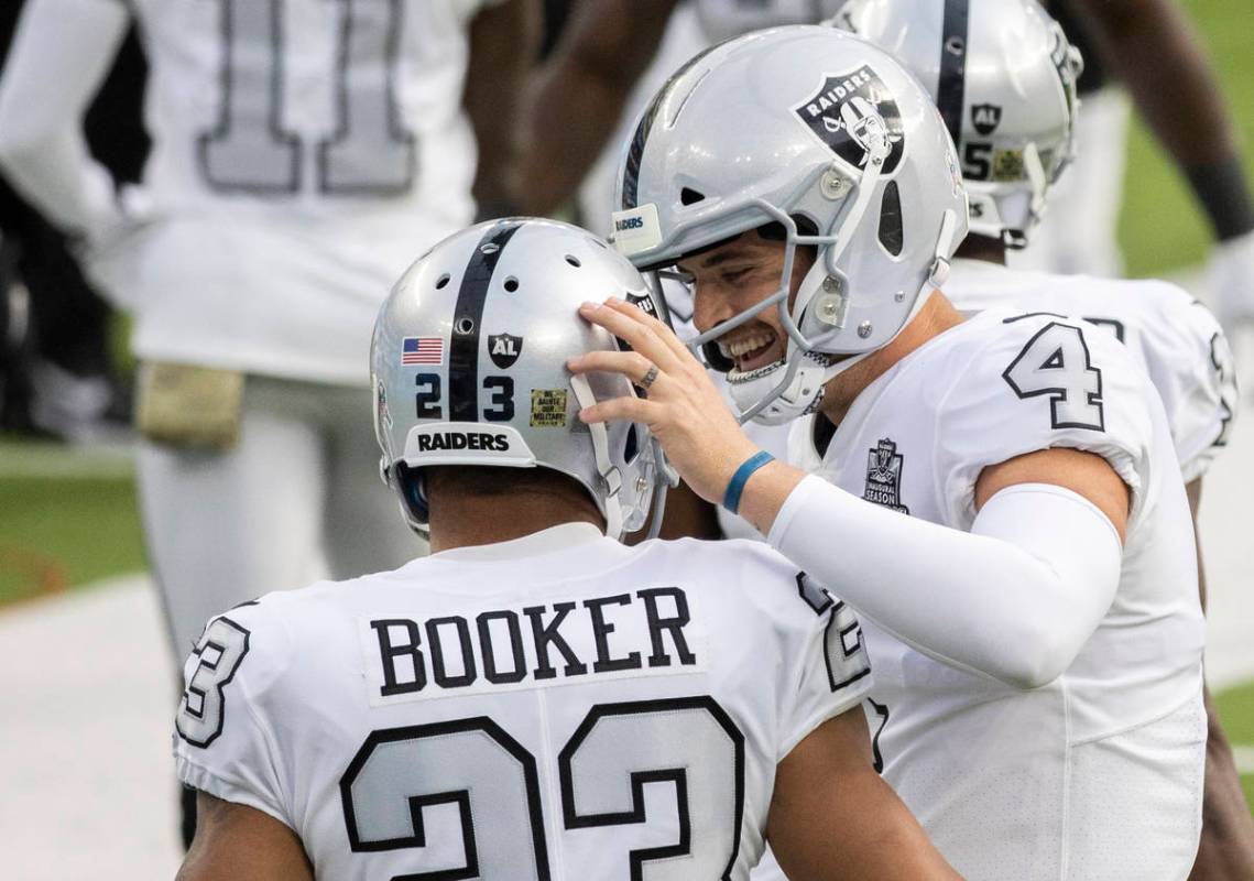 Las Vegas Raiders quarterback Derek Carr (4) celebrates a touchdown run by Las Vegas Raiders ru ...