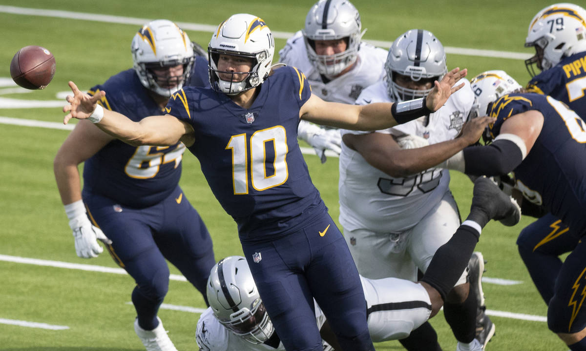 Los Angeles Chargers quarterback Justin Herbert (10) throws a pass under pressure during the fi ...