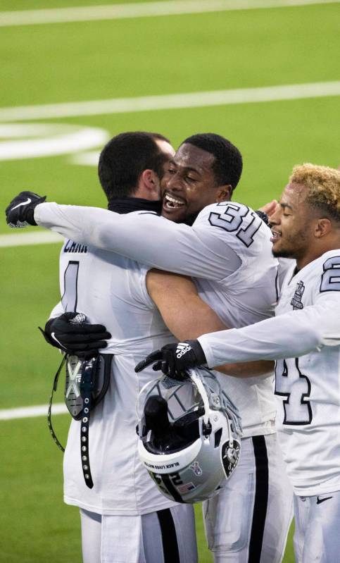 Las Vegas Raiders cornerback Isaiah Johnson (31) gets a hug from Las Vegas Raiders quarterback ...