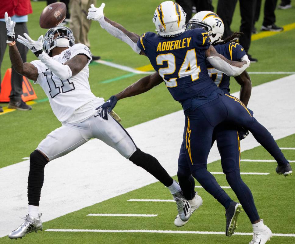 Las Vegas Raiders wide receiver Henry Ruggs III (11) leaps to try and pull in a pass over Los A ...