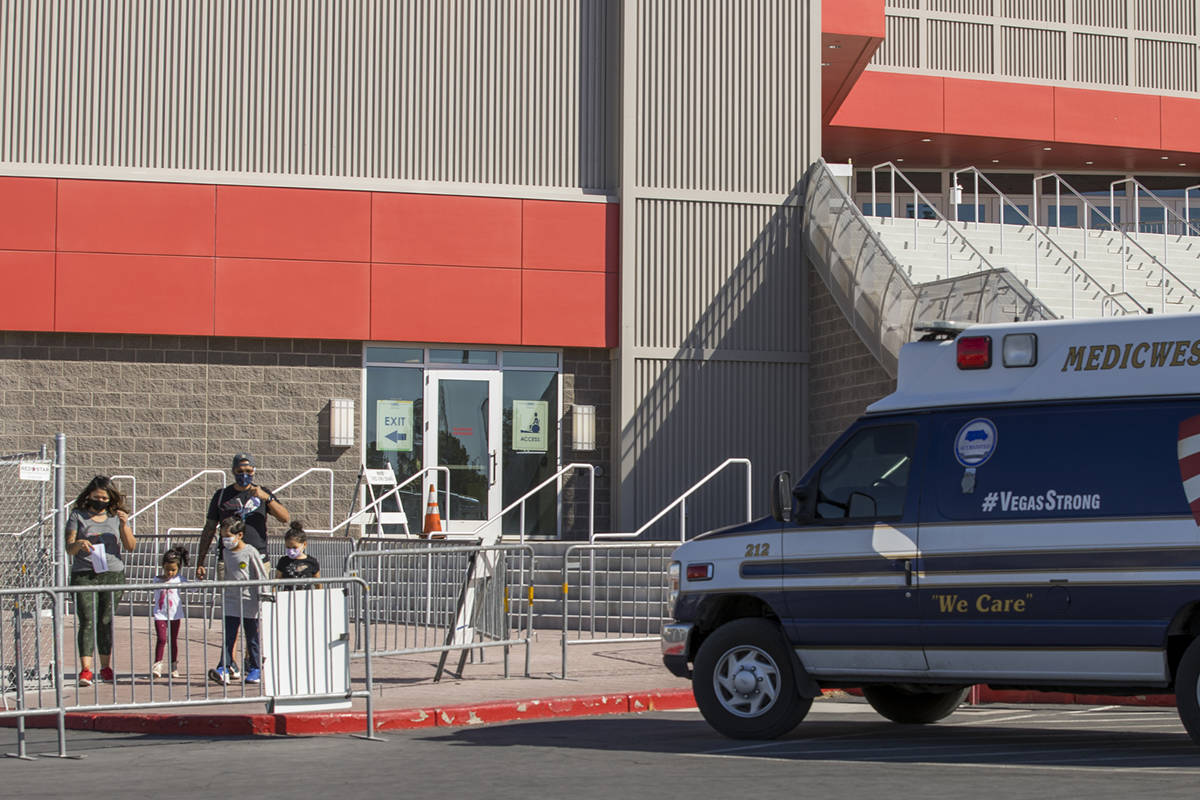 Individuals exit the free walk-up COVID-19 testing offered at the Strip Pavilion Room within UN ...