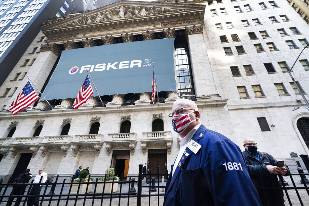 Stock trader Thomas Ferrigno arrives to work at the New York Stock Exchange, Monday, Nov. 9, 20 ...