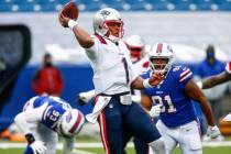 New England Patriots' Cam Newton (1) throws a pass during the first half of an NFL football gam ...