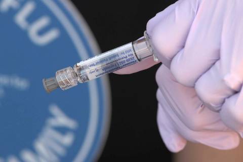 A flu vaccine is prepared to give to National Foundation for Infectious Diseases (NFID) staff m ...
