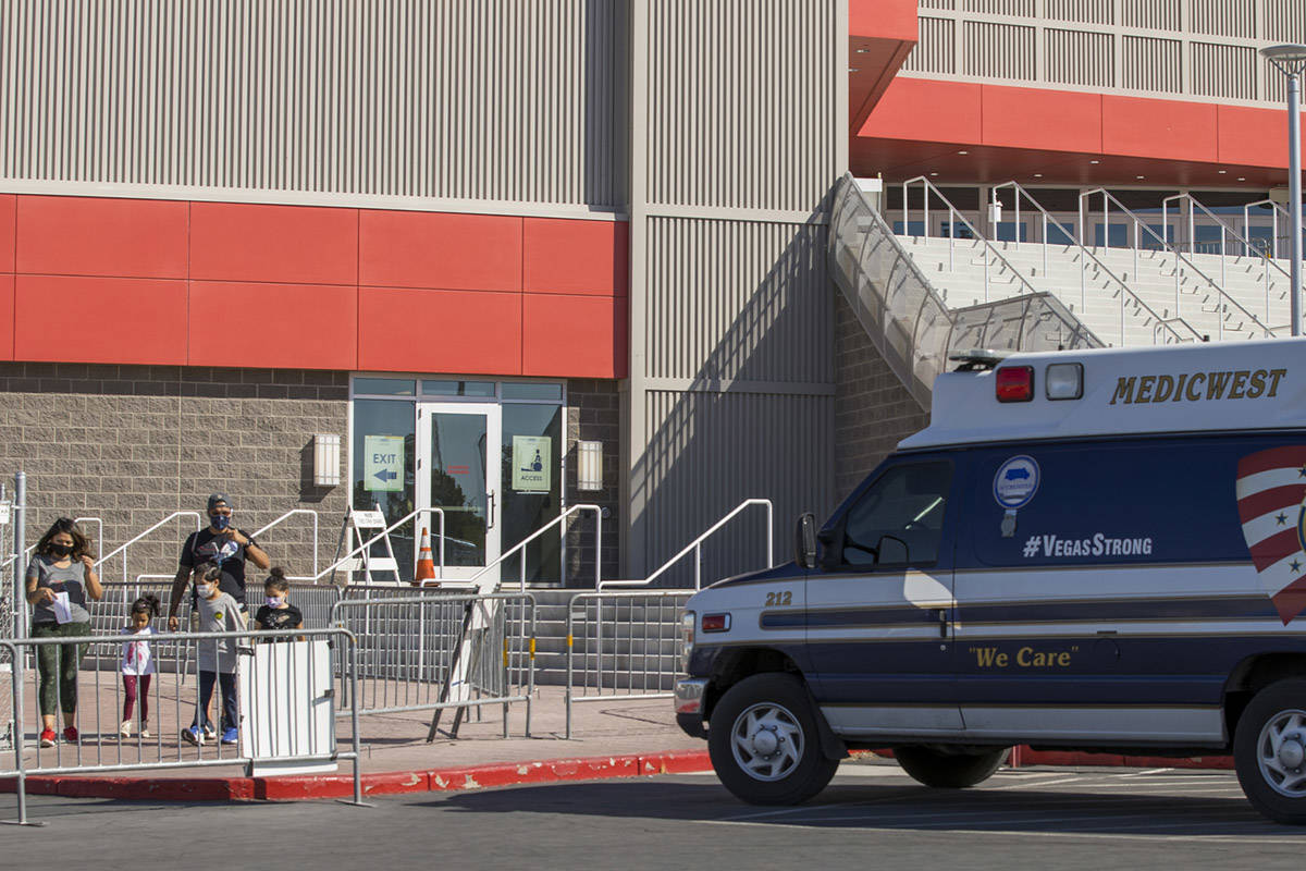 Individuals exit the free walk-up COVID-19 testing offered at the Strip Pavilion Room within UN ...