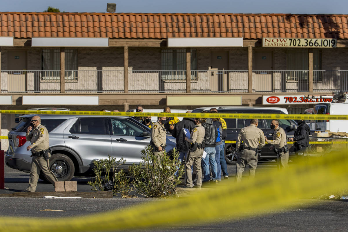 Las Vegas police meet as they investigate a homicide in the central valley near 3280 South Wynn ...