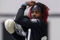 Las Vegas Raiders cornerback Damon Arnette (20) adjusts his headband during a practice session ...