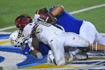San Jose State's Tre Webb (3) and Lando Grey (90) tackle UNLV's Charles Williams (8) during the ...