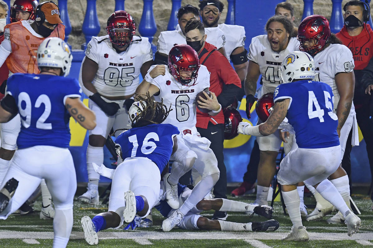 San Jose State players tackle UNLV quarterback Max Gilliam (6) along the sideline during the fi ...
