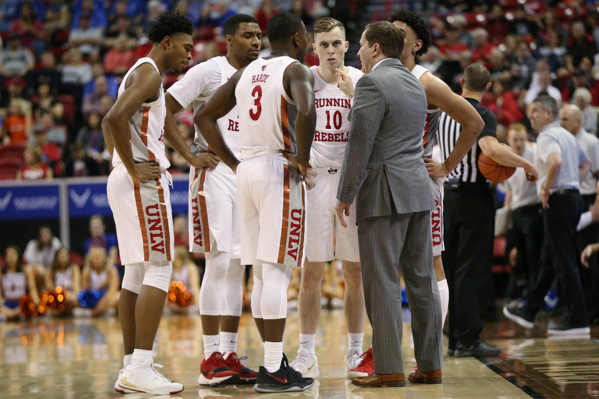 UNLV Rebels head coach T. J. Otzelberger talks to his team during a time out in the second half ...