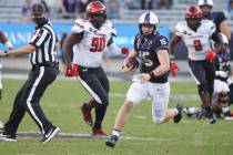 TCU quarterback Max Duggan (15) carries the ball for a first down past Texas Tech defensive lin ...