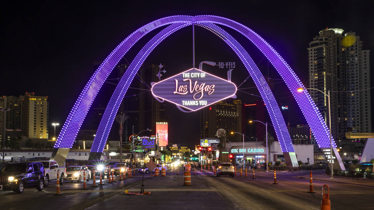 Cars stream up Las Vegas Boulevard as the downtown gateway arches are fully illuminated for the ...