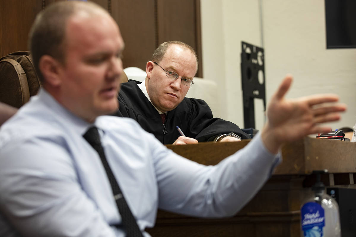 Justice of the Peace Mason Simons listens to the testimony of Detective Jeremiah Peterson of th