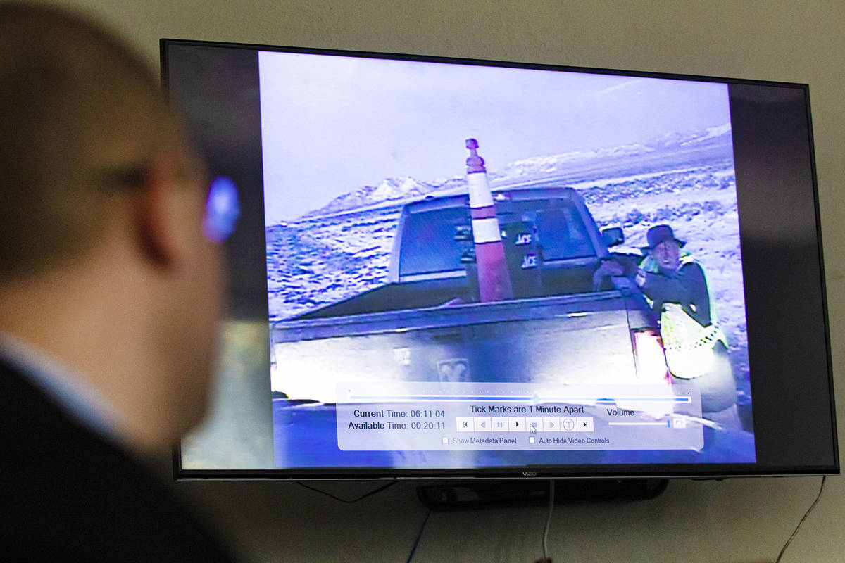 Detective Kyle McKnight, of the Nevada Department of Investigations, left, watches the dash cam ...