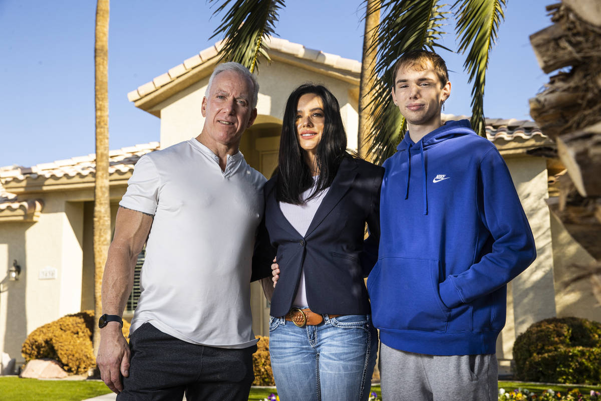 Danielle Wood, center, poses with her husband, Brian, and son, Nate, 17, at their home in Las V ...