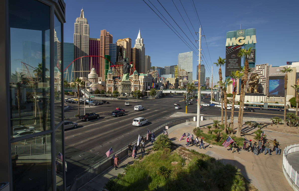 A group moves past the Tropicana during a Veterans Day march to peacefully protest Governor Ste ...