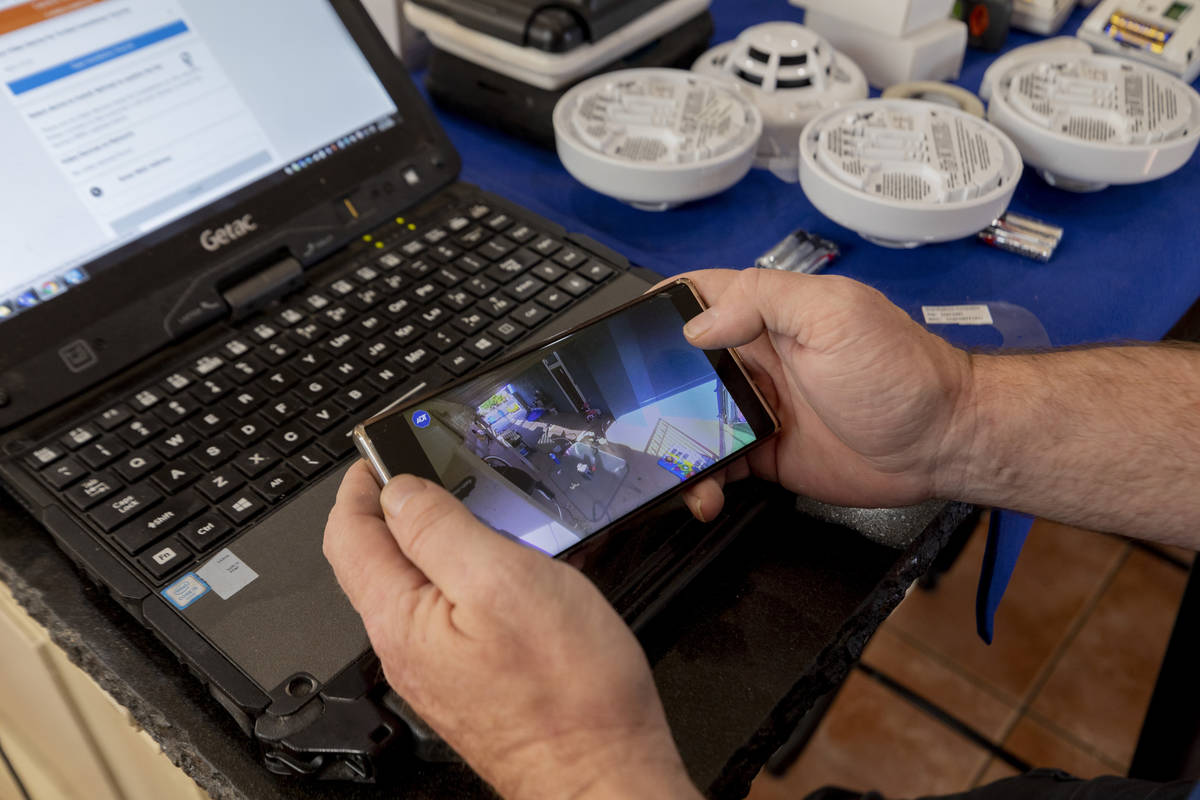 ADT Custom Home Services field service technician Paul Keplinger installs a security system in ...