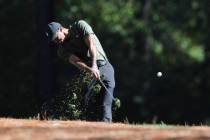 Tiger Woods tees off on the 11th hole during the first round of the Masters golf tournament Thu ...