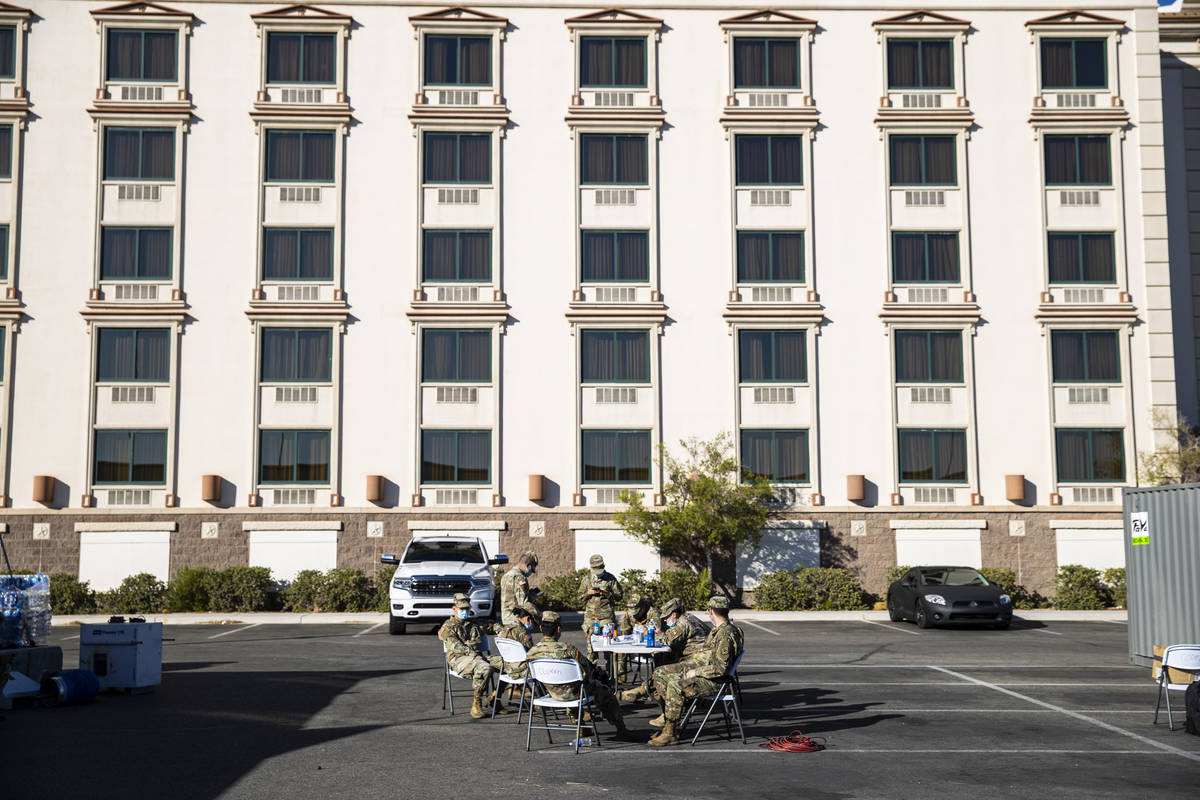 Members of the Nevada National Guard gather at a table during a preview of a drive-thru COVID-1 ...