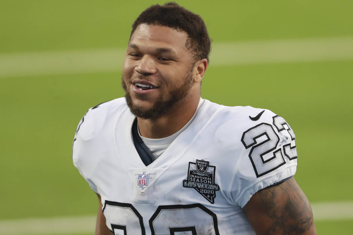 Las Vegas Raiders running back Devontae Booker (23) smiles as he walks to the locker room follo ...